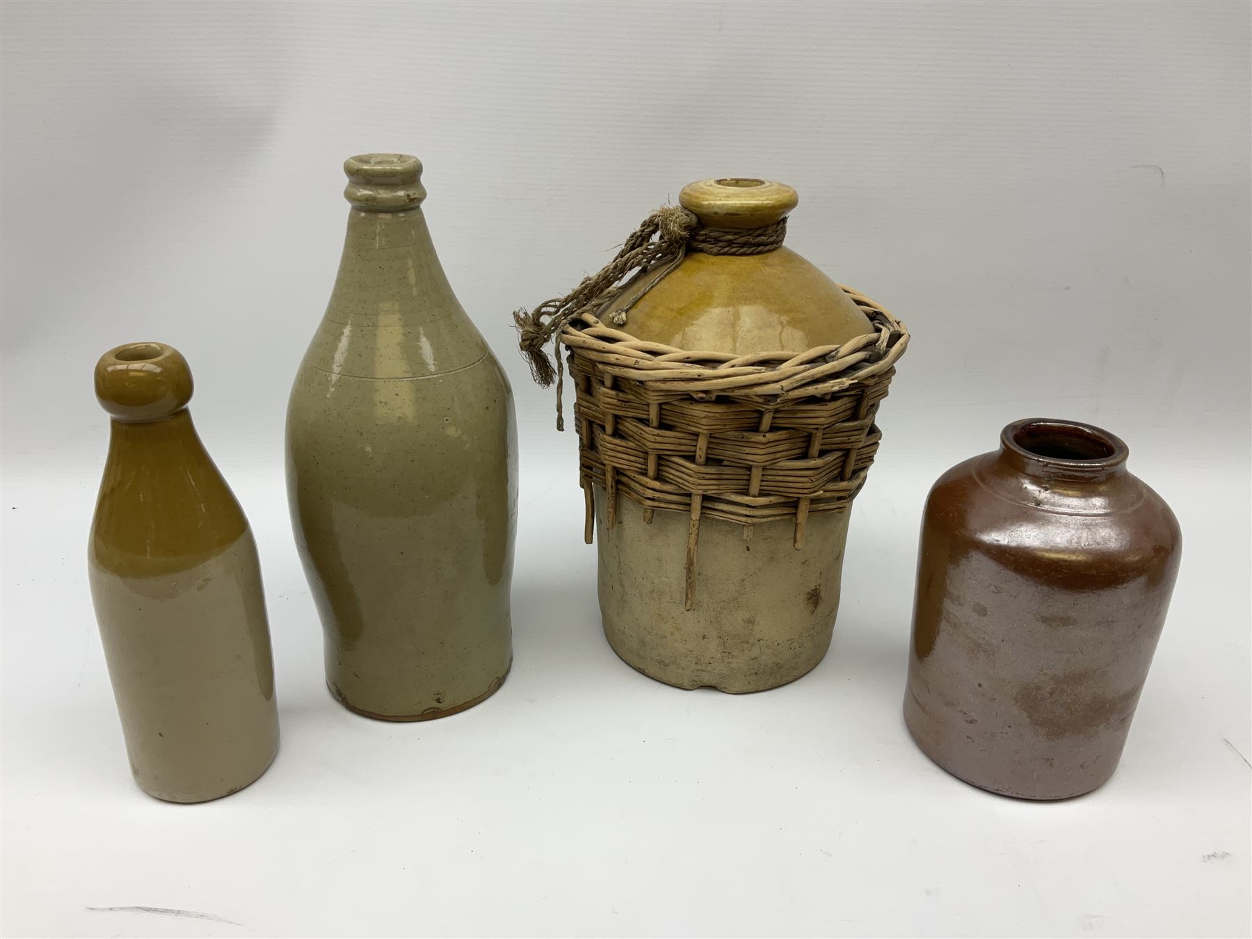 19th century stoneware gin bottle impressed I. Peck, Spirit Merchant Hull H27cm, Victorian salt glazed stoneware jar embossed W. Jefferson Mustard Manufacturer 47 Wincolmlee Hull, part cane covered stoneware flagon for John Smith Market Place Beverley and a Barton-on-Humber stoneware ginger beer bottle (4)  