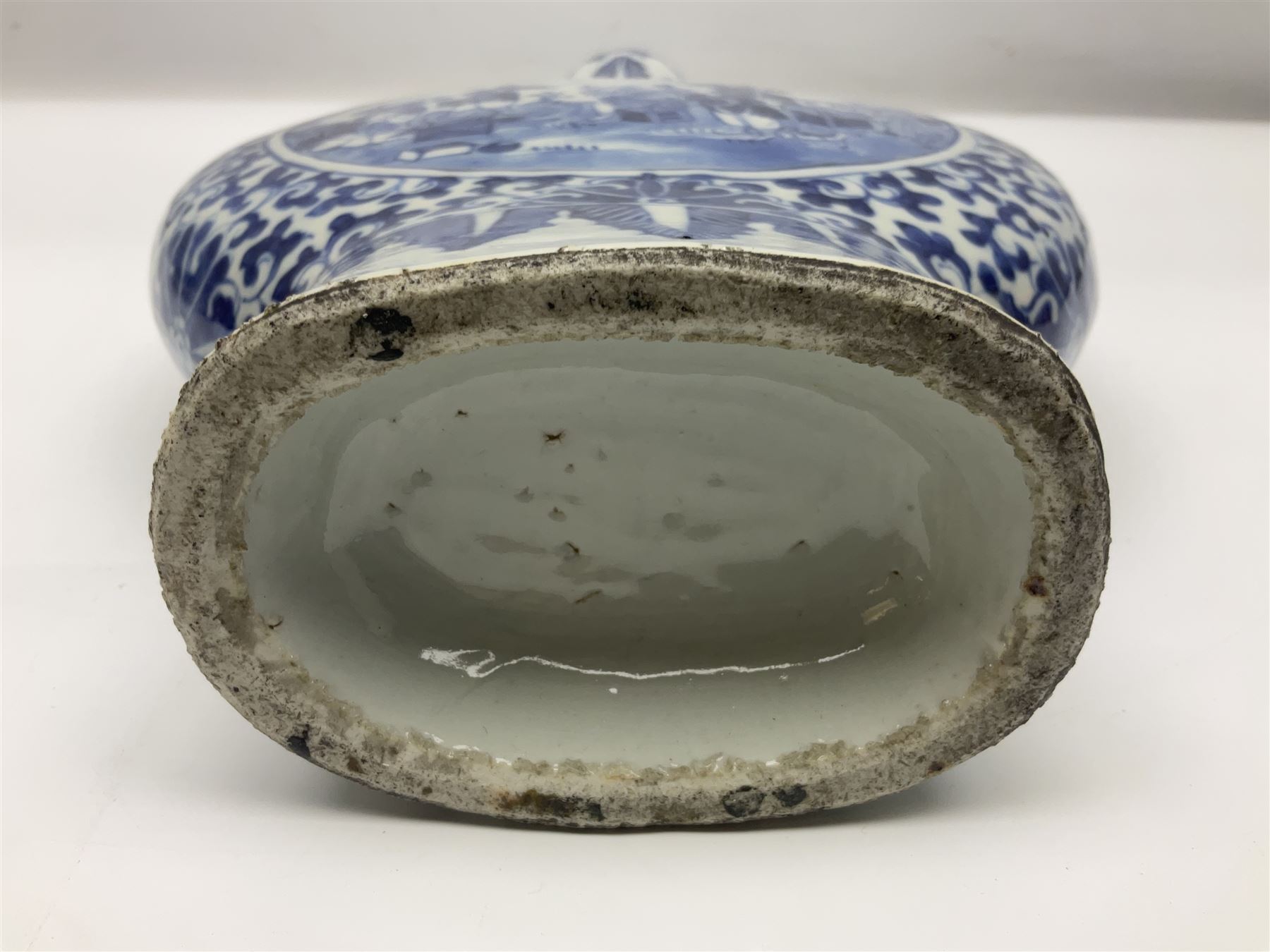 19th century Chinese blue and white moon flask vase, the central panel depicting musicians, bordered by floral, foliate and scroll decoration, with lizard handles to each shoulder, upon an oval foot, H31cm 