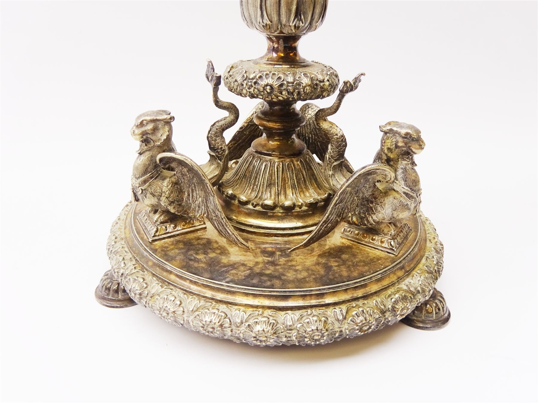 A large Victorian Thomas Bradbury & Sons silver plated candelabrum, the circular base with flower head border upon three domed feet, supporting a central knopped and fluted column flanked by three zoomorphic creatures, leading to a central socket with removable nozzle above a large palmette detailed drip pan, and three scrolling branches with conforming sockets and nozzles, with maker's silver plate mark and Victorian registration lozenge beneath, H62.5cm