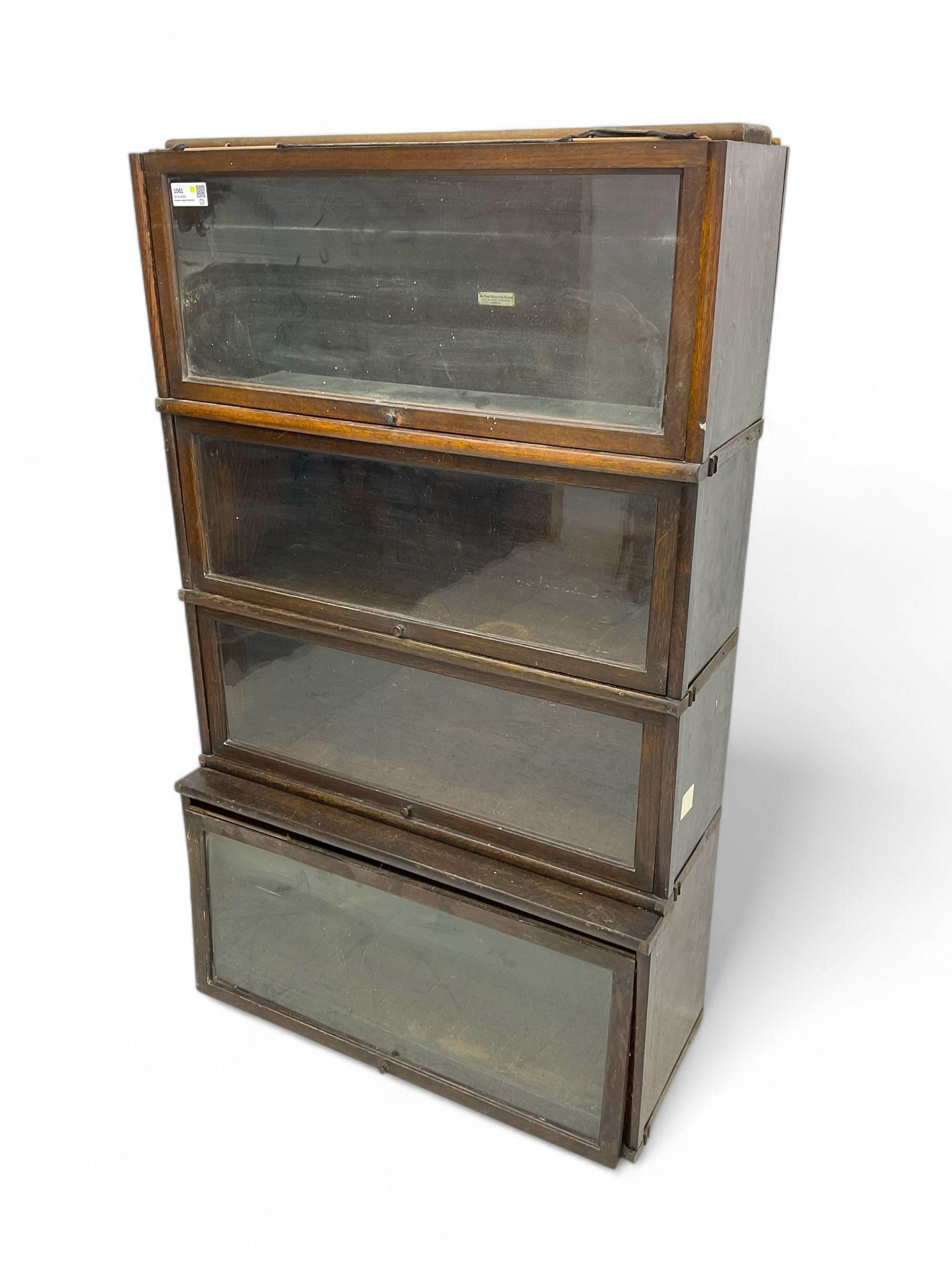 Globe Wernicke - early 20th century oak four-tier stacking library bookcase, four glazed sections enclosed by hinged and sliding doors