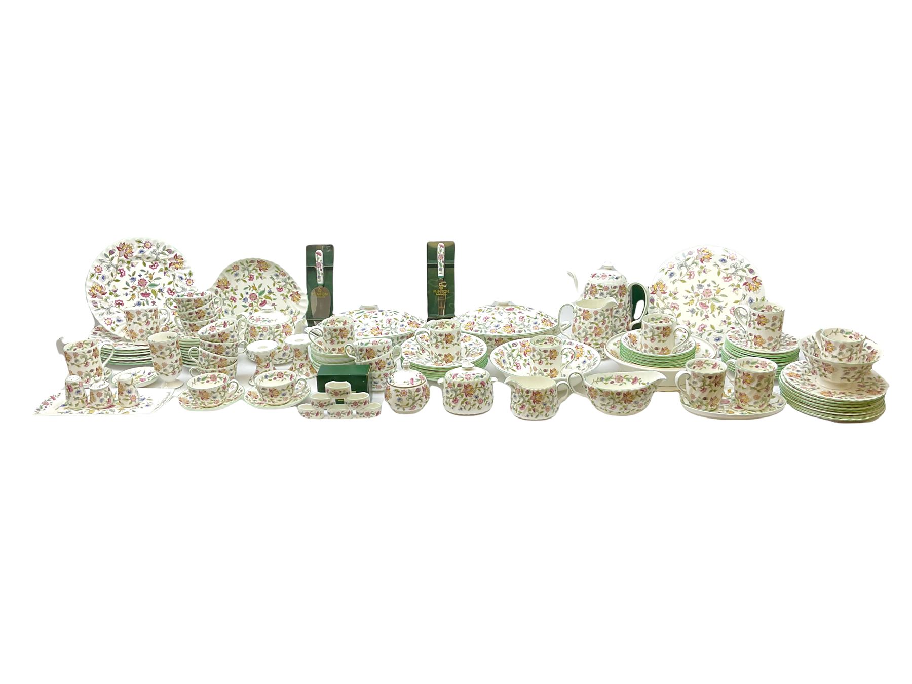 Minton Haddon Hall pattern tea and dinner wares, including basket dish, two covered tureens, six dinner plates, eight dessert plates, twelve tea plates, six soup bowls, six cereal bowls, teapot, coffee pot, milk jug, covered sucrier twelve tea cups and saucers, six mugs, footed bon bon dish, pair of candlestick holders, cake knife and slice etc (81)