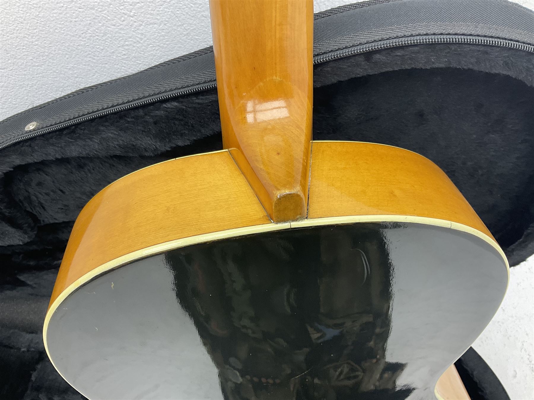 1950s acoustic guitar with f-holes and pickguard L105cm; black fur lined hard carrying case