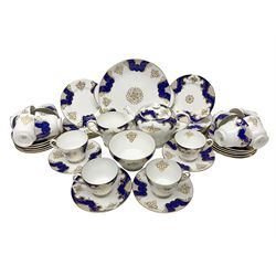 Shelley Empire pattern tea service for twelve, decorated with borders of electric blue and gilt foliate design on plain white ground, pattern no 14078, comprising fourteen saucers, fourteen tea plates, cake plate, twelve teacups, teapot, bowl and jug, all with printed marks beneath