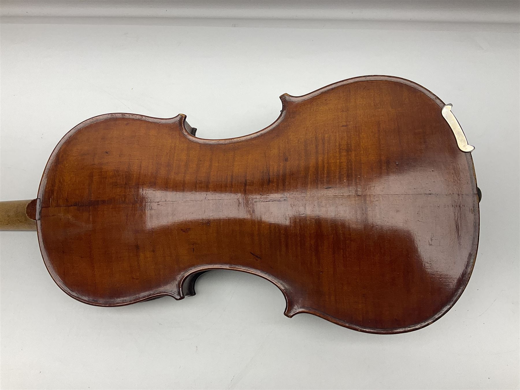 German violin c1890 with 36cm two-piece maple back and ribs and spruce top; bears label 'Antonius Stradivarius Cremona Faciebat Anno 1729' L59.5cm overall; in ebonised wooden 'coffin' case; and two German violins c1890 for completion - one bearing a Stradivarius label, the other a Ruggeri label; both in carrying cases (3)