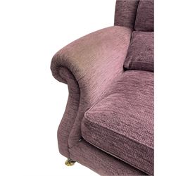 Parker Knoll - pair of large two-seat sofas upholstered in purple fabric, turned mahogany finish front feet with brass cups and castors 