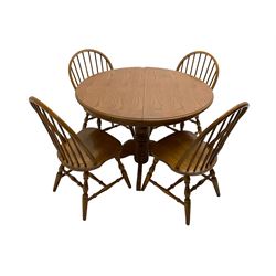 Oval extending dining table, raised on turned pedestal with quadrupod base, with additional leaf (W108cm H73cm); and set four hoop and stick back chairs, raised on turned supports united by stretchers (W45cm H90cm)