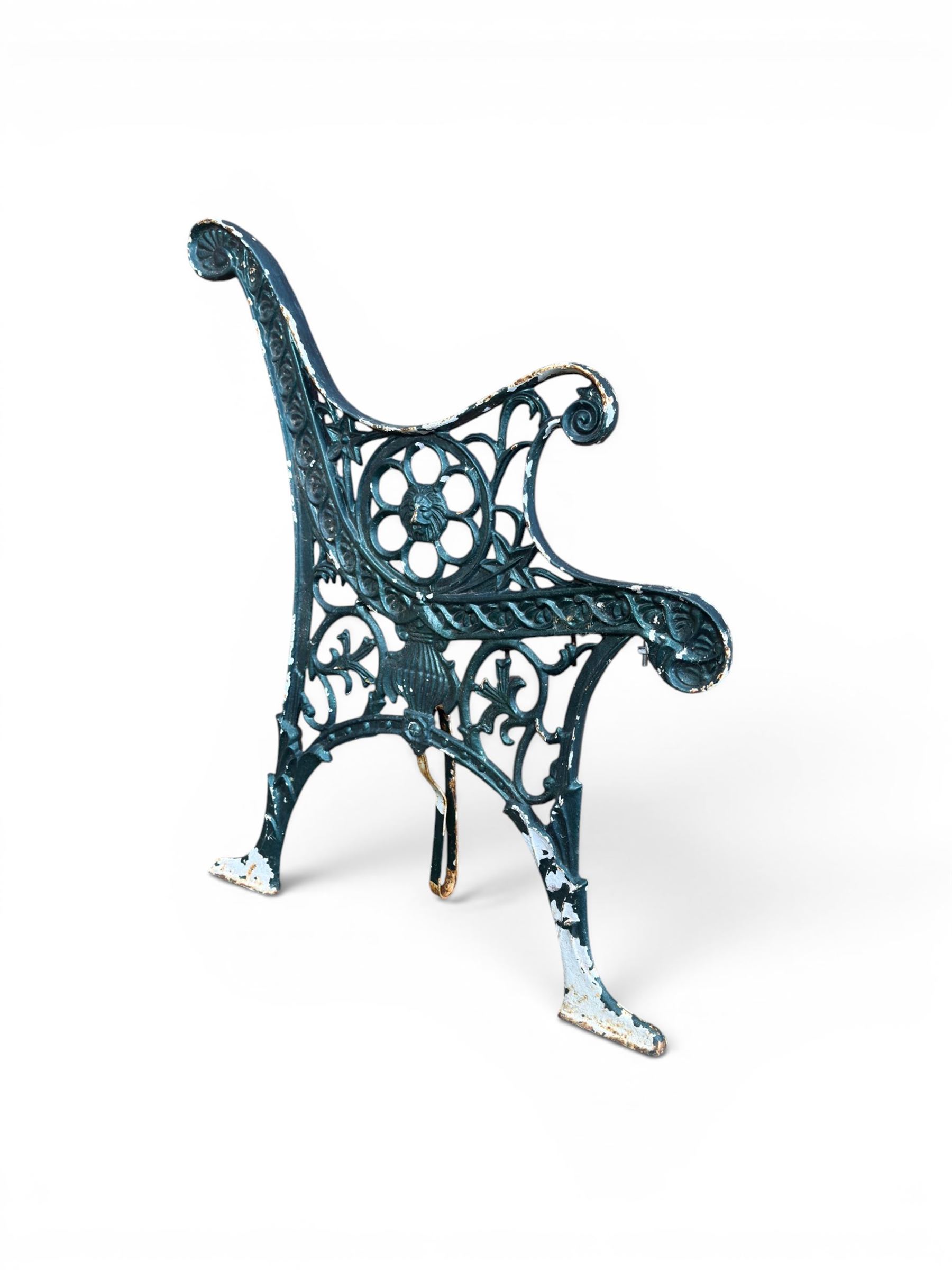 Pair of ornate painted cast iron bench ends, painted in green