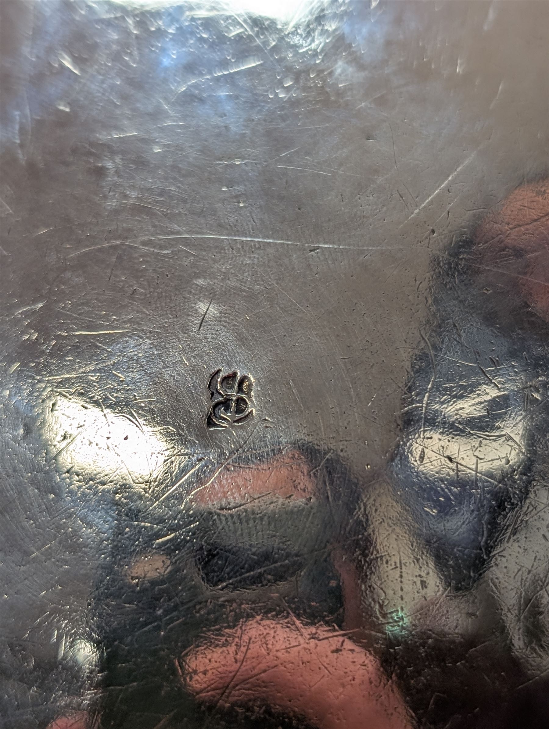 Northern European silver peg tankard, probably late 18th/early 19th century, of cylindrical form, the body repoussé decorated with scrolling and blossoming acanthus, fitted with scroll handle with shield terminal, the hinged cover with conforming repoussé decoration surrounding a central circular panel engraved with monogram beneath initials EASBGD, opening with ball thumbpiece detailed with fruits, raised upon three confirming ball feet mounted with shaped panels also detailed with fruits, bearing indistinct mark beneath, H19cm