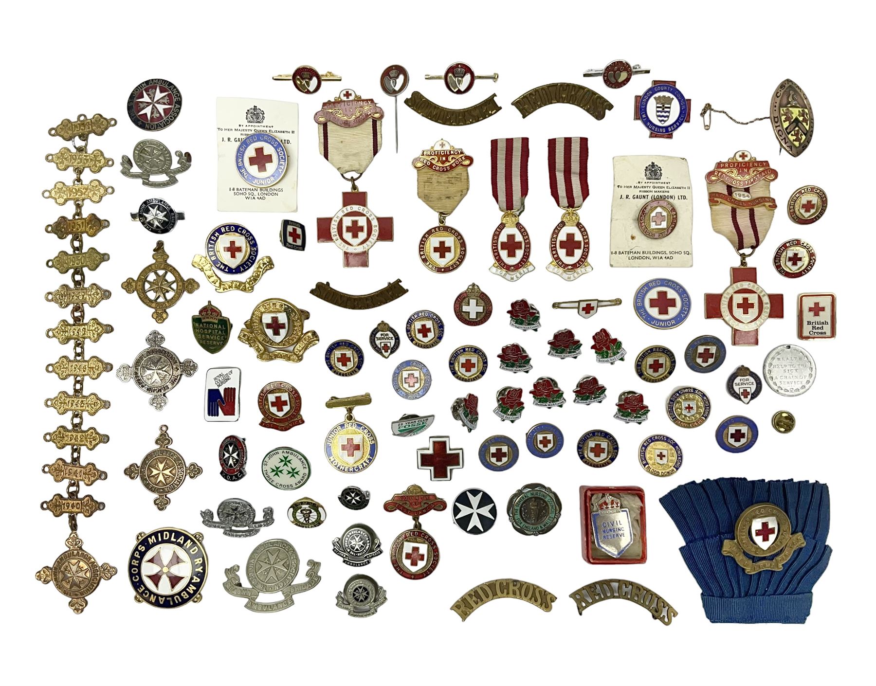 Collection of St John Ambulance enamel and metal badges, together with Red Cross medals and badges