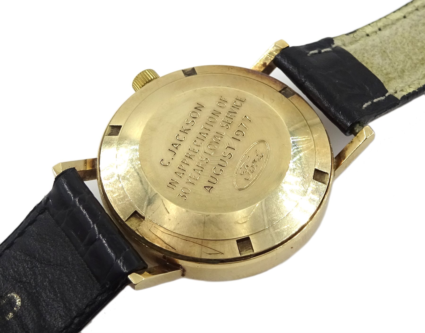 Garrard 9ct gold gentleman's automatic wristwatch, with date aperture, presented by Ford to C Jackson, hallmarked London 1976, on leather strap in original Ford case
