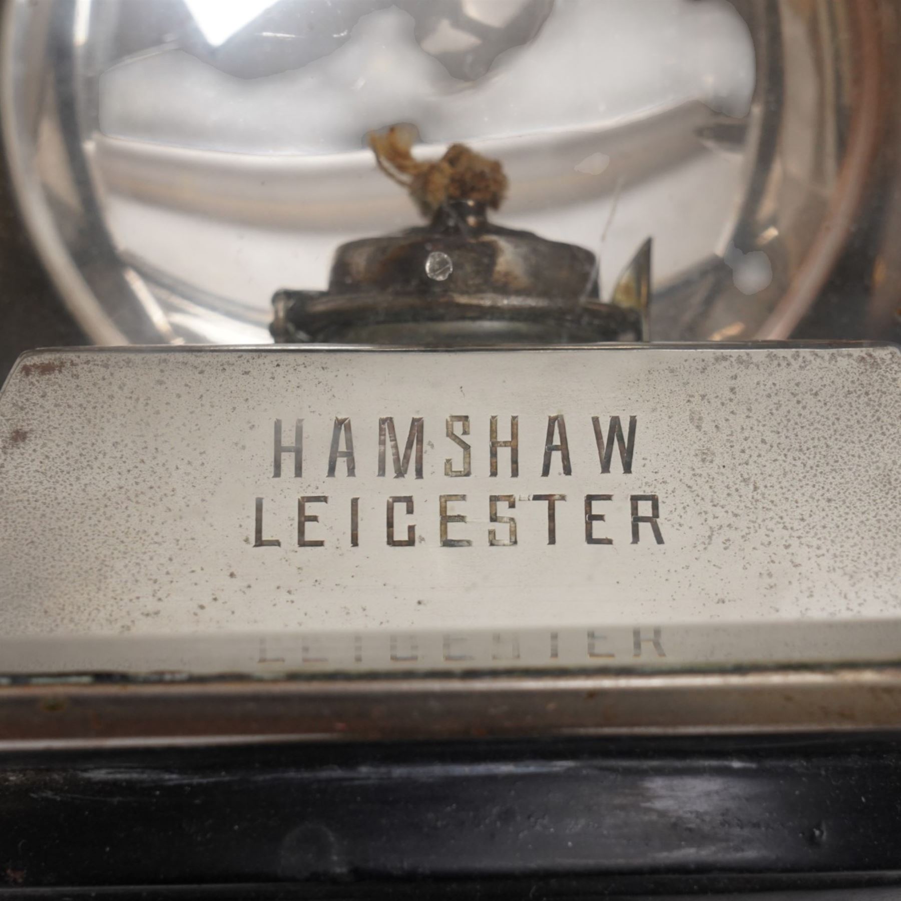 Hamshaw (Leicester) - pair of Edwardian white metal and toleware carriage lamps, the pagoda moulded with patera motif, over a rectangular body with oval convex lens and bevelled glass and reflective panels, cylindrical stem, maker engraved to candle mount

