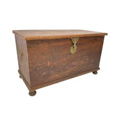 Hong Kong camphor wood chest, rectangular hinged top, carved all over with traditional scenes and dragon boats, on bun feet