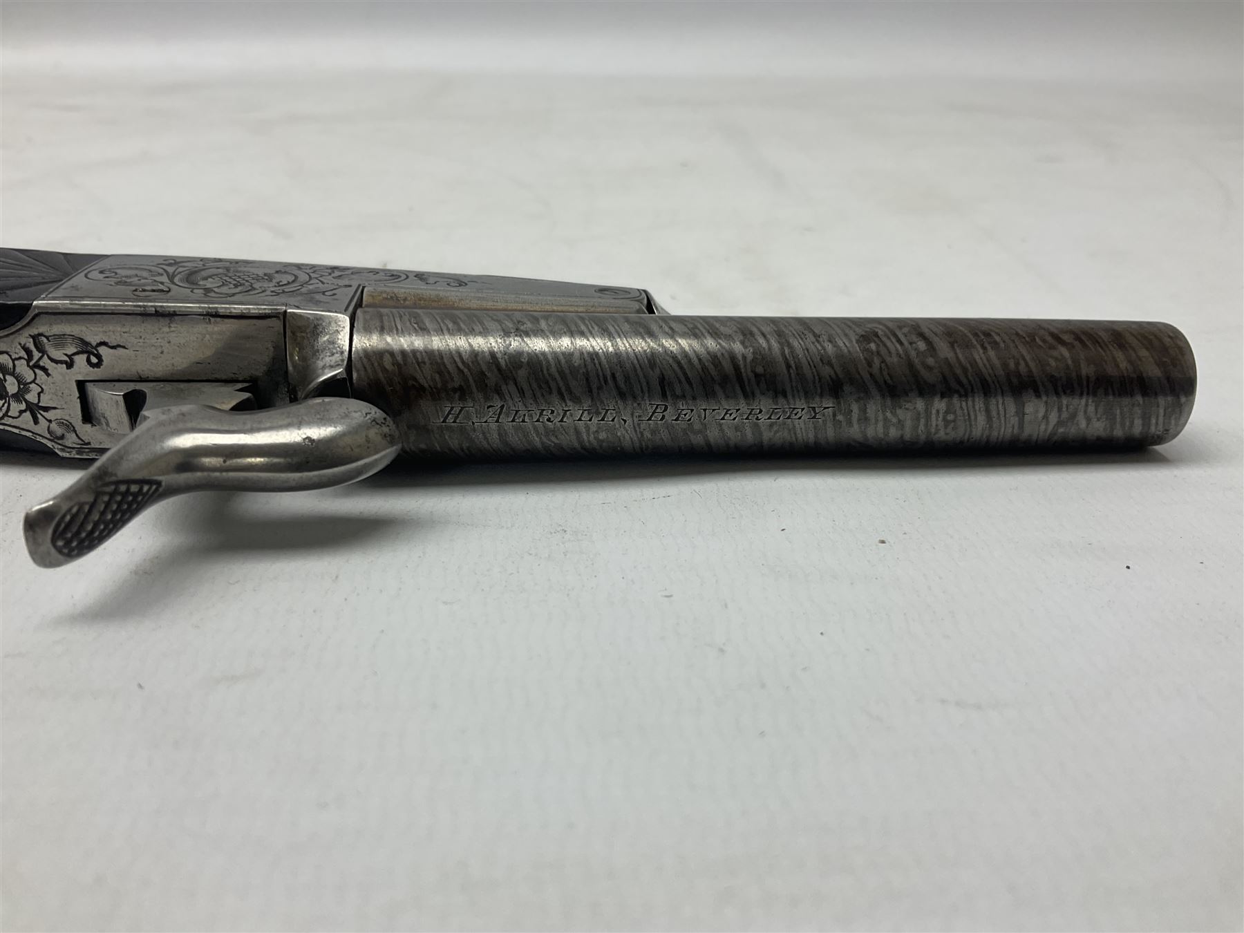 Mid-19th century French Boissy 12mm single barrel pin-fire pistol, the 9.5cm rifled barrel with brown stub twist damascus decoration, side screw under lever opening and English proof marks, retailed by H. Akrill Beverley, chased action with drop-down trigger and carved walnut stock L21cm