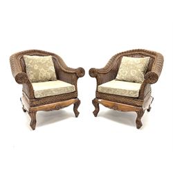 Pair cane armchairs, seat cushions upholstered in a beige floral patterned fabric, carved cabriole supports