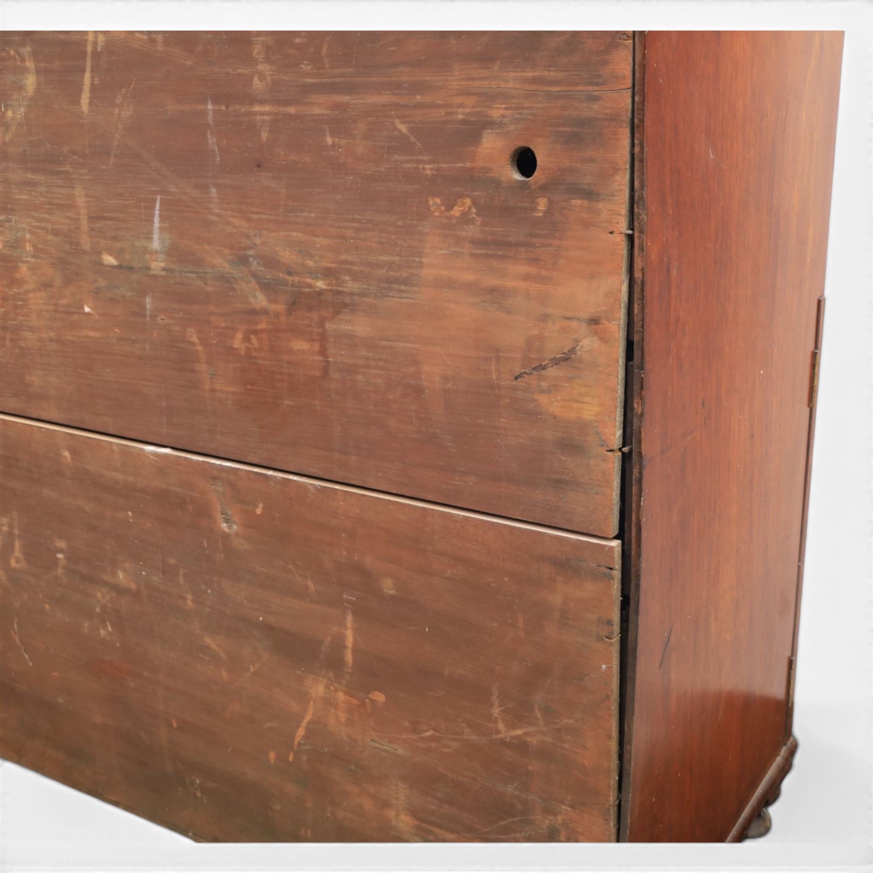 Early 19th century mahogany secretaire-bookcase, projecting cornice above astragal glazed cabinet with adjustable shelved interior, fall front secretaire drawer, fitted interior with pigeonholes and drawers, flame mahogany fronted cabinet with three drawers, on turned supports 