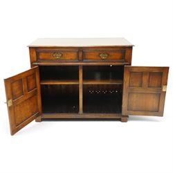 18th century style oak dresser base, rectangular moulded top over two frieze drawers with brass handles, twin panelled cupboard doors below with pierced brass escutcheons, on stile feet