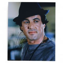 Four Sylvester Stallone film stills and promotional shots, including one depicting Rocky Balboa in the ring, three signed by Sylvester Stallone and one signed by Brigette Nielsen, all with certificates of authenticity