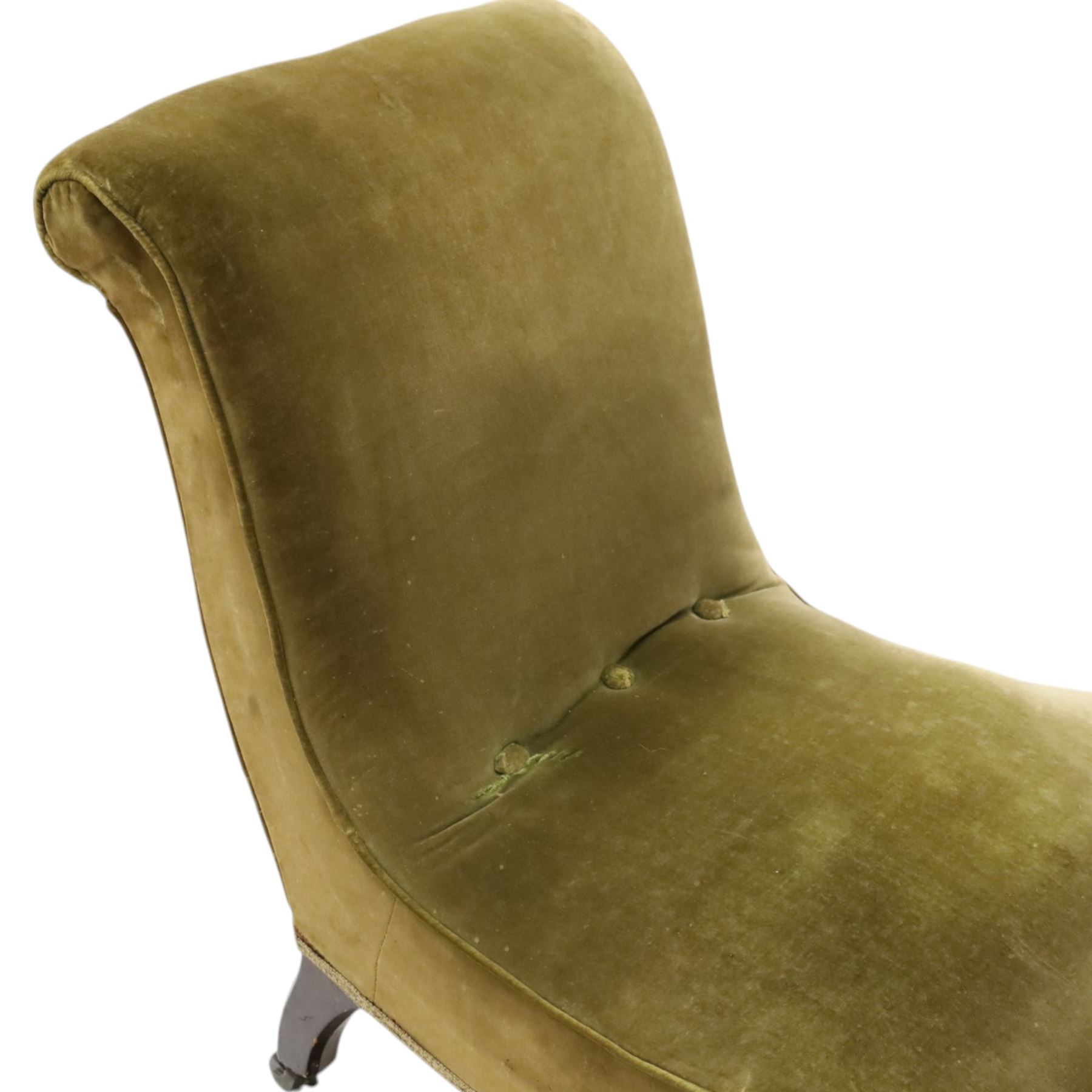 Victorian mahogany framed slipper chair, of reclined shape with rolled back over sprung seat, raised on turned feet with ceramic castors