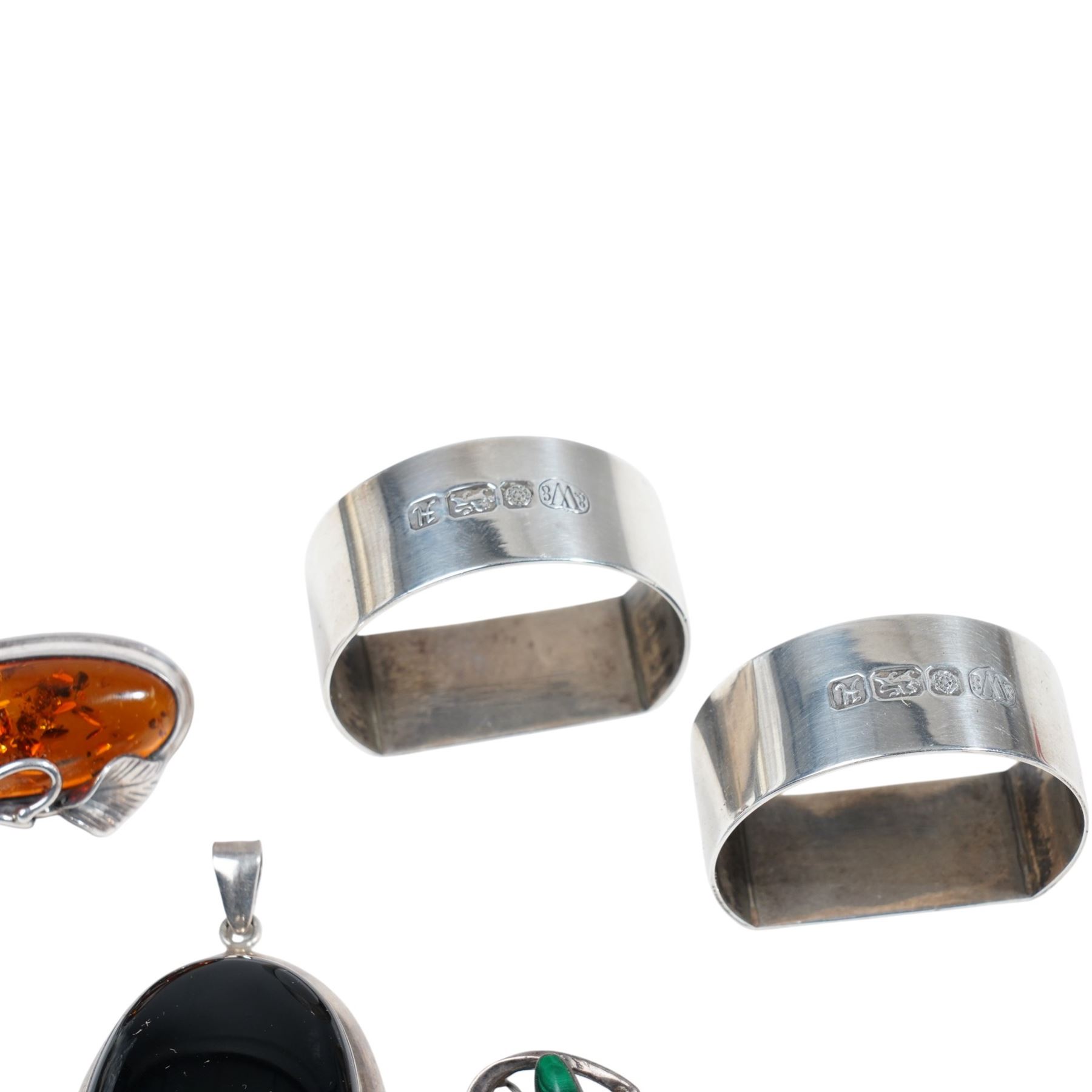 Two silver serviette rings, possibly by Warriss & Co, Sheffield 1982 and silver stone set jewellery including an amber set brooch/ pendant and pair of earrings, malachite brooch etc 