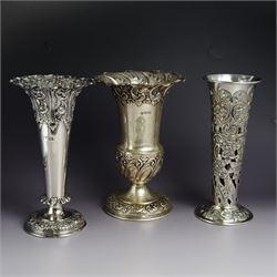 Three late 19th century/early 20th century silver vases, of trumpet form, all embossed with floral and foliate decoration, one example with weighted base, all hallmarked, tallest H18cm