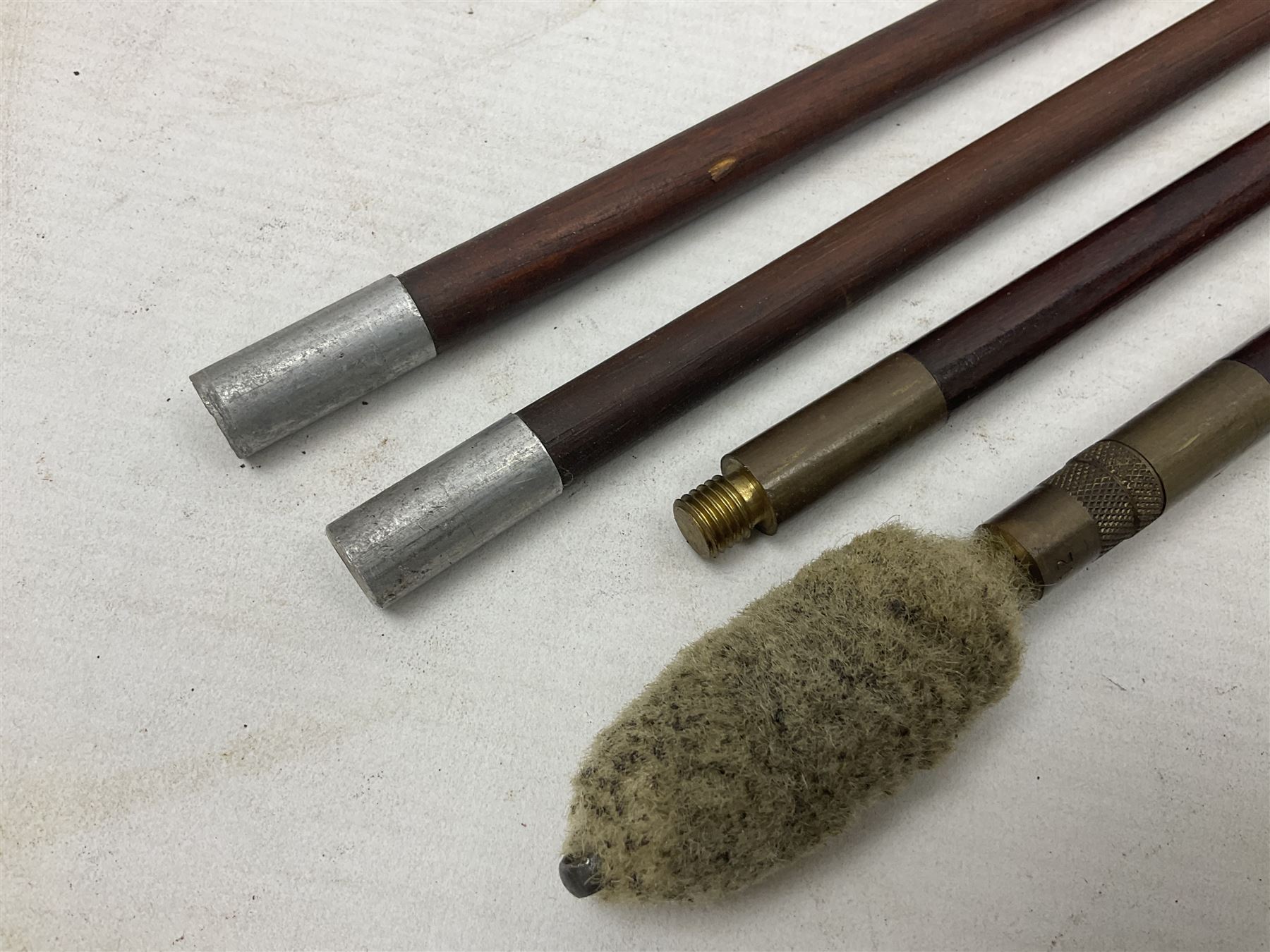 George V 1897 pattern Infantry officers sword, the 82cm single fullered blade with traces of etched detail and George V crown cipher, the ricasso marked Hawksworth Sheffield, pierced half basket hilt with George V cypher, wire-bound fish-skin grip with brass pommel and backstrap; in leather scabbard L102cm overall; together with two sectional gun cleaning rods; swagger stick made of leather strips etc