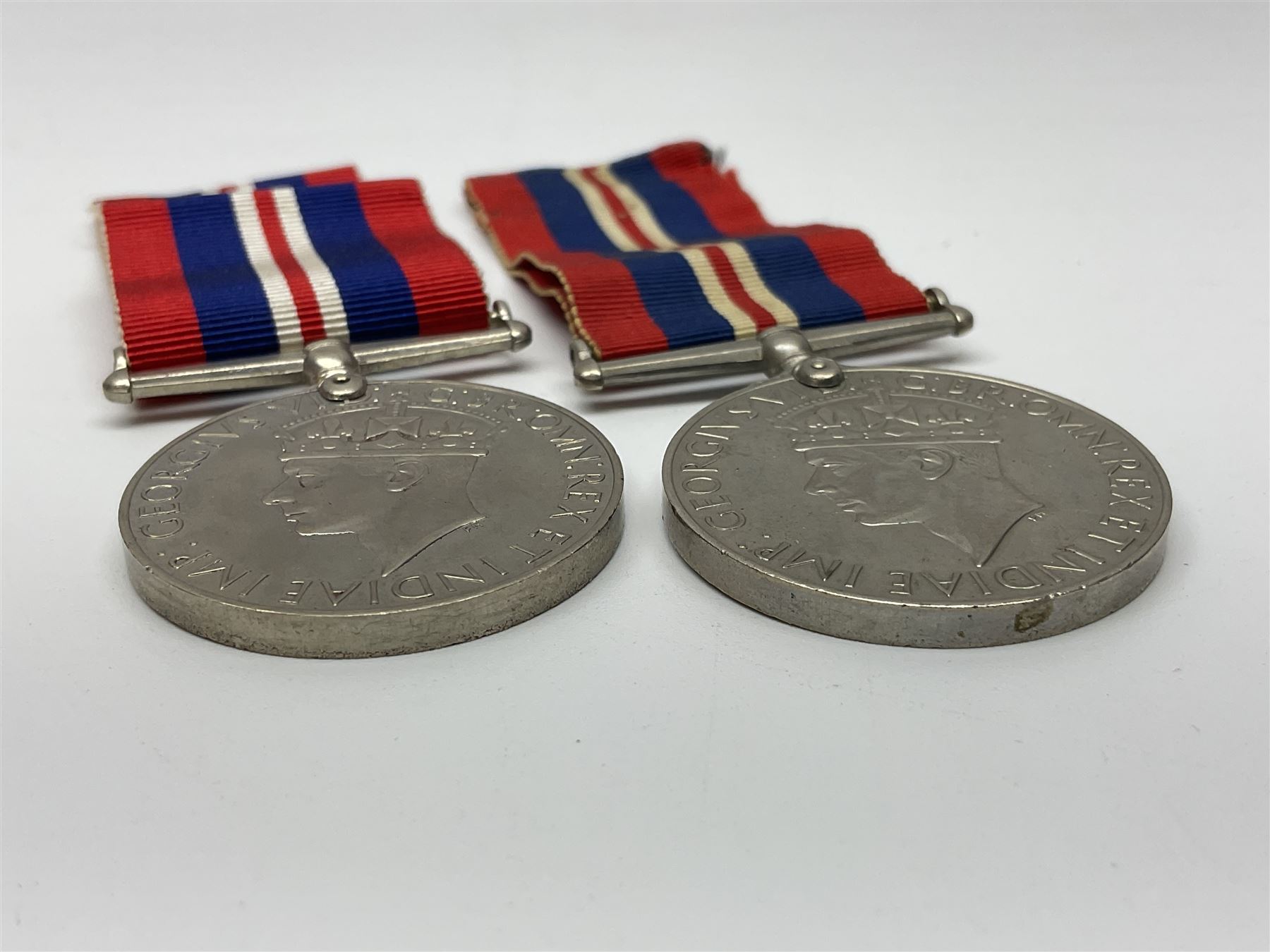 Ten WW2 medals comprising two 1939-1945 war medals, two Defence medals, two 1939-1945 Stars, two Africa Stars, France & Germany Star and Burma Star; together with bar of four miniature medals; all with ribbons
