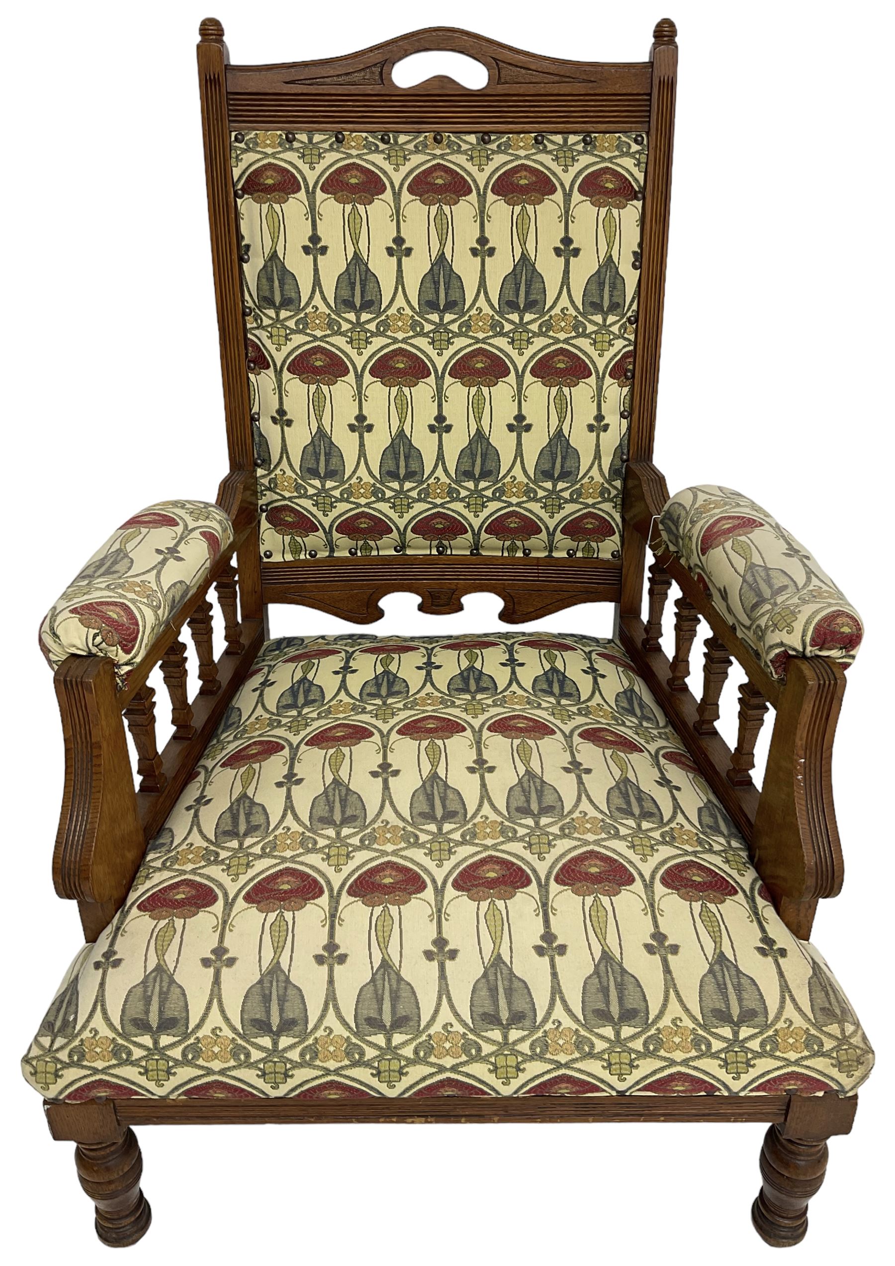 Early 20th century armchair, back and sprung seat upholstered in Art Nouveau patterned fabric, raised on ring turned supports, the frame with all-over reeded decoration