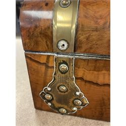 19th century walnut and brass bound games compendium box, painted to enhance the grain, of rectangular form, the hinged opening cover with rounded sides, central brass cartouche with engraved lion crest, and brass riveted straps, opening to reveal a red leather and blue silk lined compartmented interior, with fold-down games board, and lift-out tray containing playing cards, ebony turned dice towers, white and red stained bone draughts, and chess pieces, ivory dice, and ivory and ebony whist markers, and brass bezique board, cribbage board and markers, H15cm W32cm D24cm
This lot has been registered for sale under Section 10 of the APHA Ivory Act