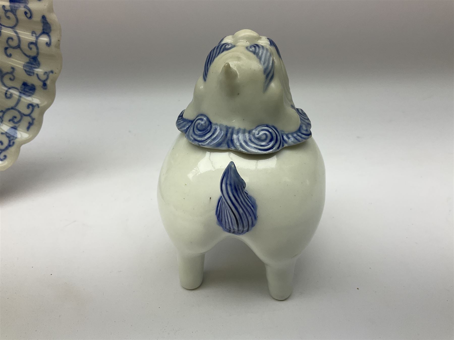 Japanese Hirado blue and white porcelain censer in the form of a Lion Dog, together with a Hirado porcelain shell shaped dish, centrally decorated with an exotic bird flanked by two roundels on floral scroll ground, censer H13cm