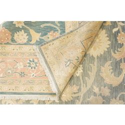 Indo-Persian indigo ground carpet, the field decorated with large palmette motifs connected by scrolling foliate, enclosed nu wide guard bands decorated with repeating interlaced stylised plant motifs
