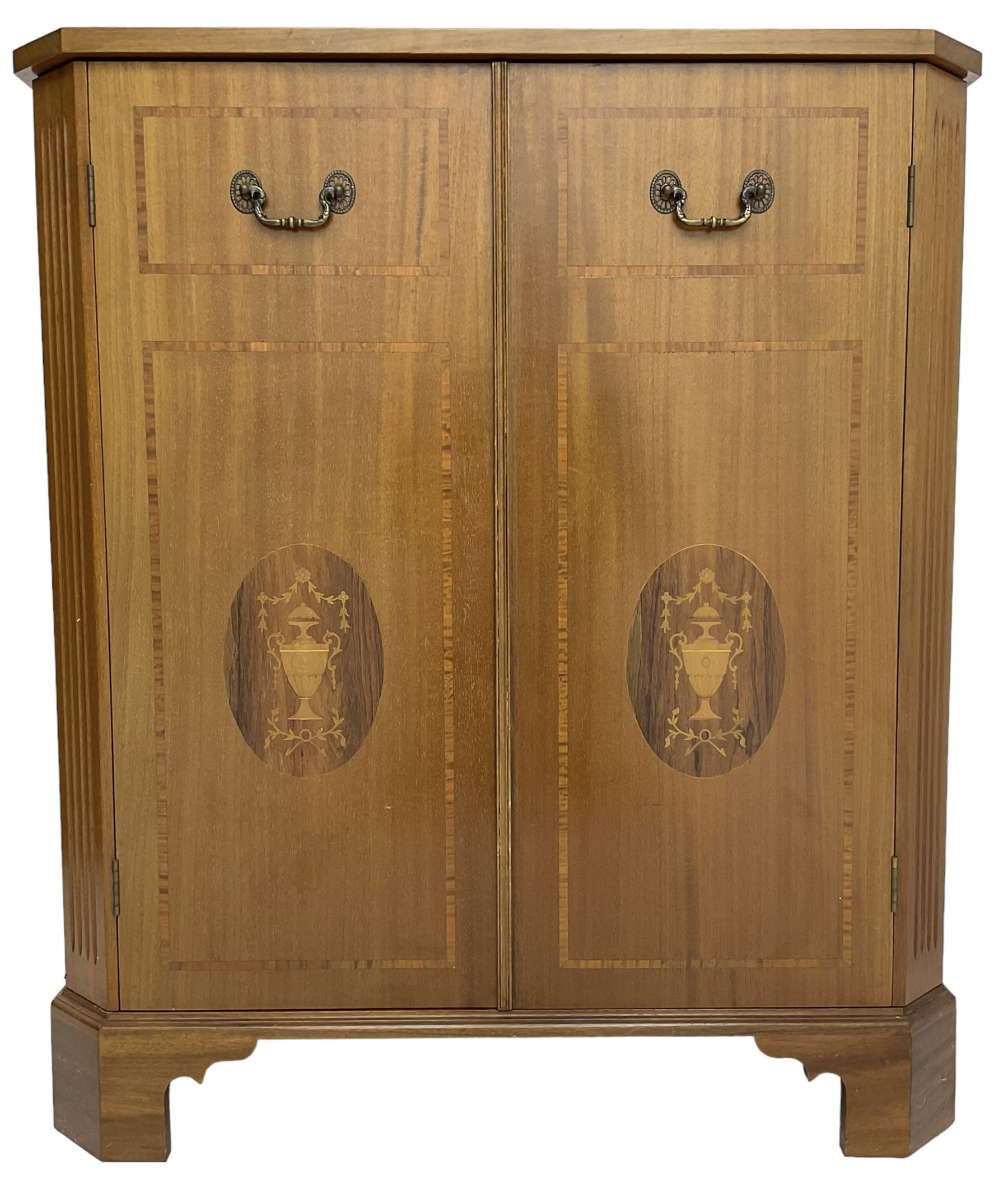 John More of Scarborough -  Edwardian Revival 'Canterbury Cabinet' inlaid mahogany cabinet, fitted with double cupboard decorated with urn motif inlays and banding, flanked by canted fluted uprights, on bracket feet