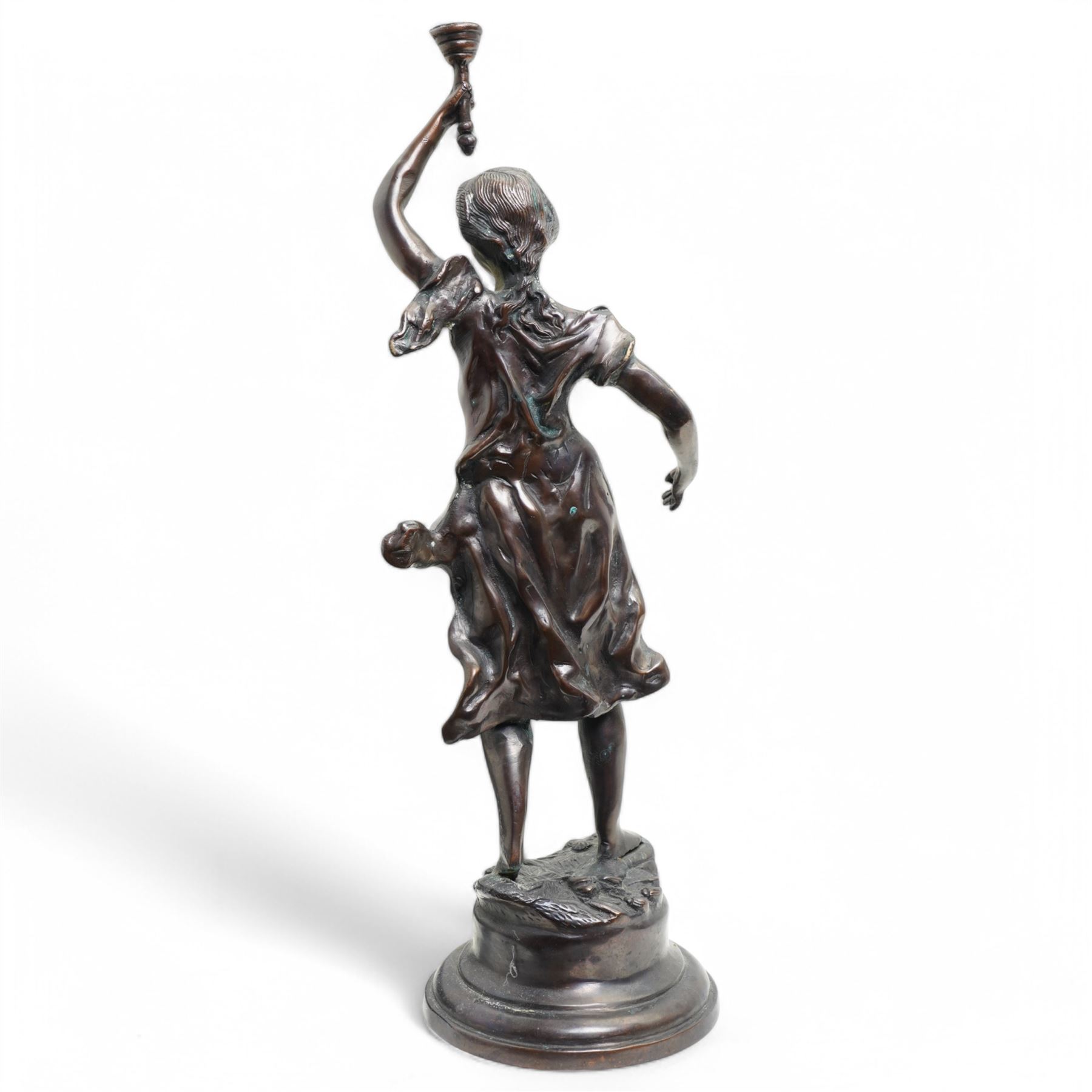 After Victor Rousseau (1865-1954)  - bronze sculpture of a lady holding aloft a torch and on circular base H50cm