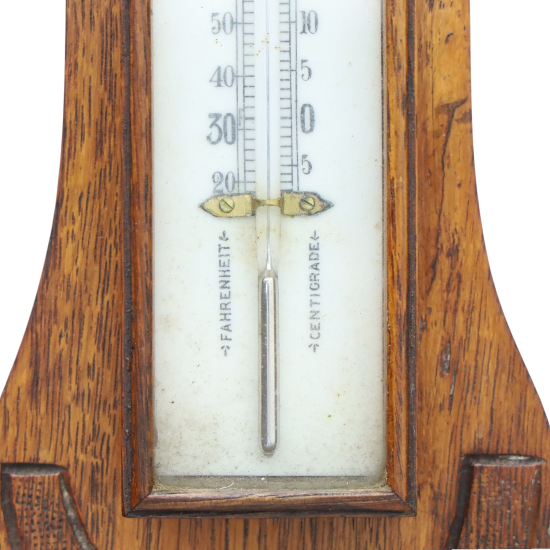 Late Victorian carved oak aneroid barometer, the foliate crest above a glazed thermometer and circular dial, with further carved decoration below, H 75cm