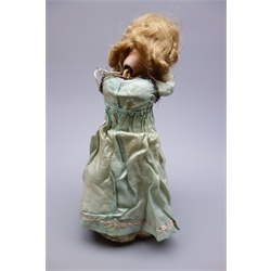 Early 20th century French Henri Rostal Mon Tresor bisque head musical pull-along doll, with blue glass eyes, open mouth with teeth, blonde wig and bisque lower arms, wearing original silk dress on conical base with three inset metal spoked wheels, H31cm   