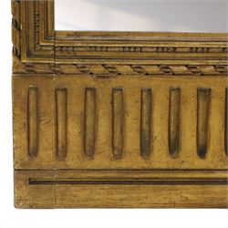 Early 20th century gilt and bevelled mirrored four panel folding screen, with two mirrors per side, flanked by beaded edges and scrolled finials, arcaded carved frieze