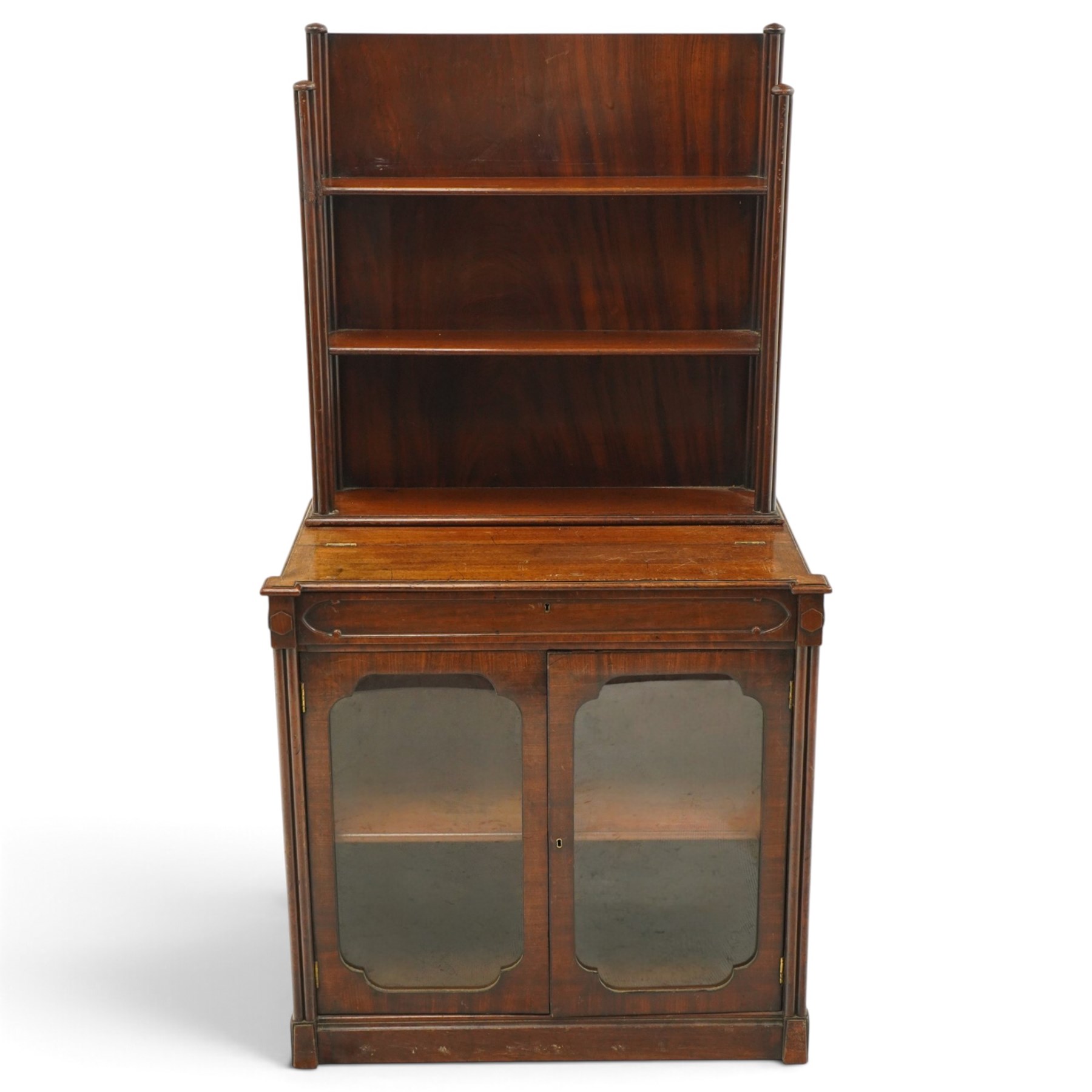 Late 19th century Gothic Inspired secretaire-chiffonier, the raised superstructure with two open shelves and cluster-column uprights, the base fitted with hinged top over secretaire drawer with hinged slope writing surface and pen-rest compartments, over a twin glazed doors enclosing single shelf, the flanking cluster-columns on skirted base