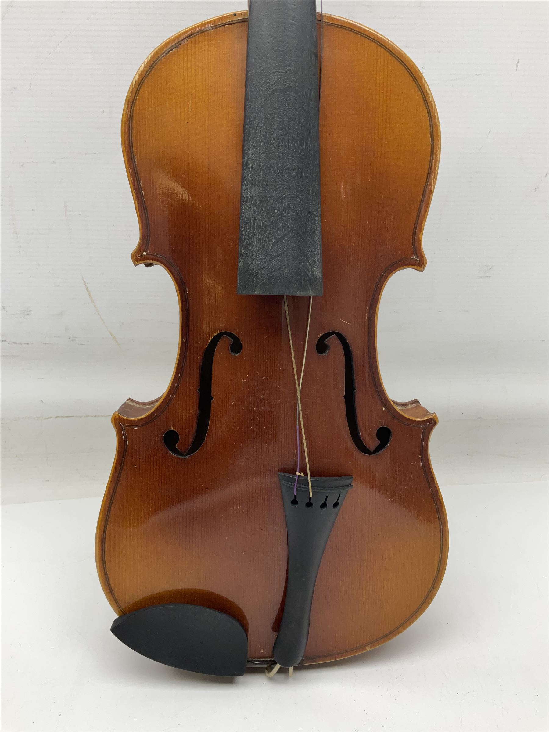 Czechoslovakian violin c1920 with 36cm two-piece maple back and ribs and spruce top, bears label 'Copy of Antonius Stradivarius Made in Czechoslovakia' L59cm; in carrying case; 1950s Czechoslovakian violin; and 195os Czechoslovakian three-quarter size violin; both cased (3)