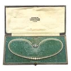  Single row graduating pearl necklace with diamond clasp, retailed by Z. Barraclough & Sons, Leeds, in original box  