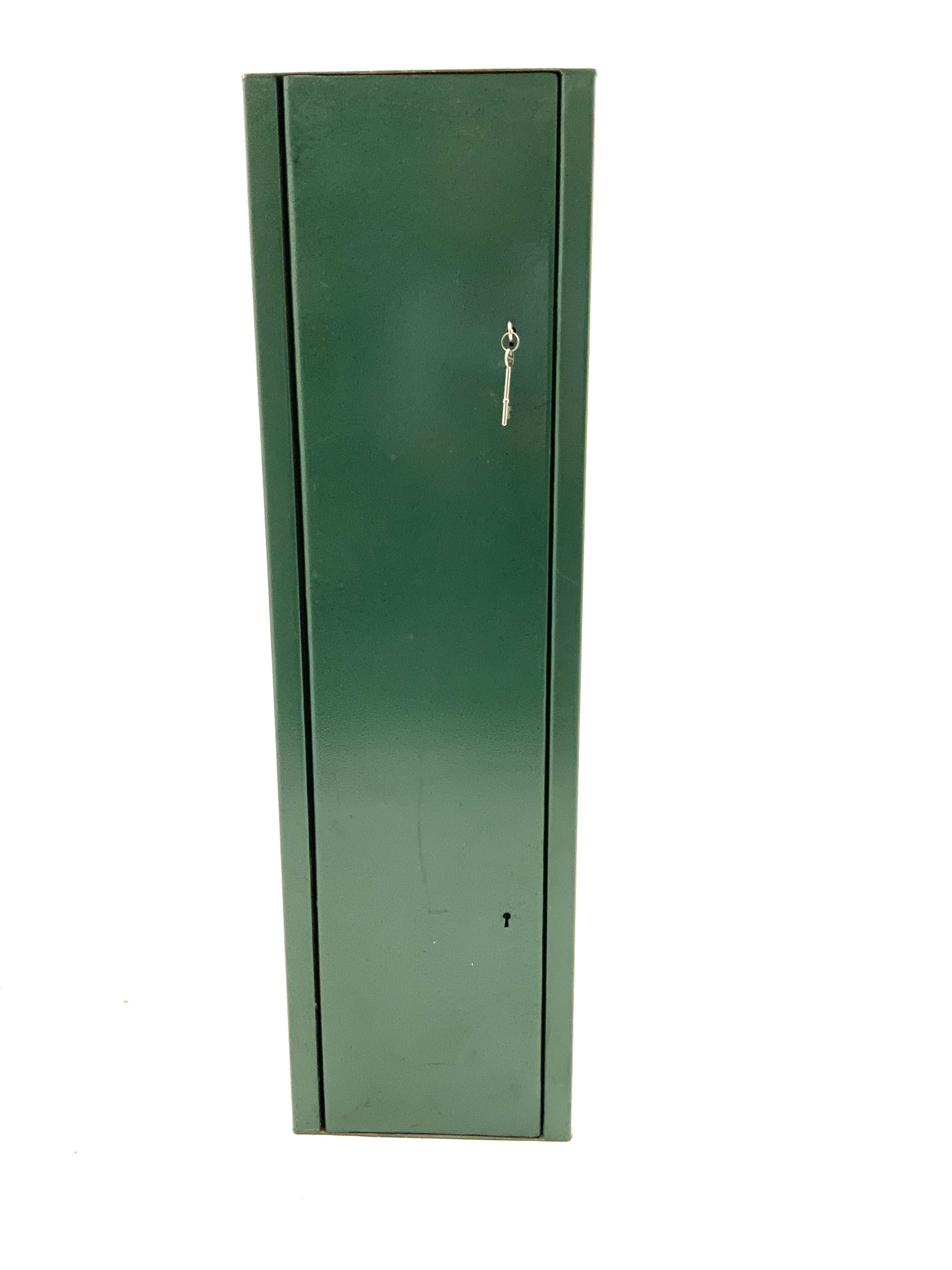 Green metal gun cabinet with keys 