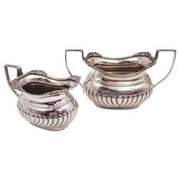 Late Edwardian silver milk jug and sugar bowl, each of typical part fluted form with angular handles, hallmarked S Blanckensee & Son Ltd, Chester 1909, tallest H8.5cm