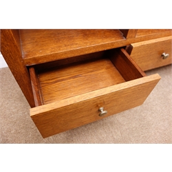  Medium oak open bookcase, nine shelves above three drawers, W127cm, H143cm, D39cm  