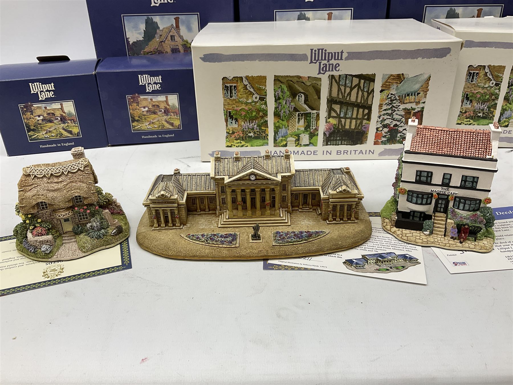 Eight Lilliput Lane models, including Gertrude's garden, Cruck End, Honeysuckle cottage, The Pottery, Huddersfield Railway Station, The Magpie Cafe, Amberly Rose, Summer Days and Shades of Summer, all boxed with deeds
