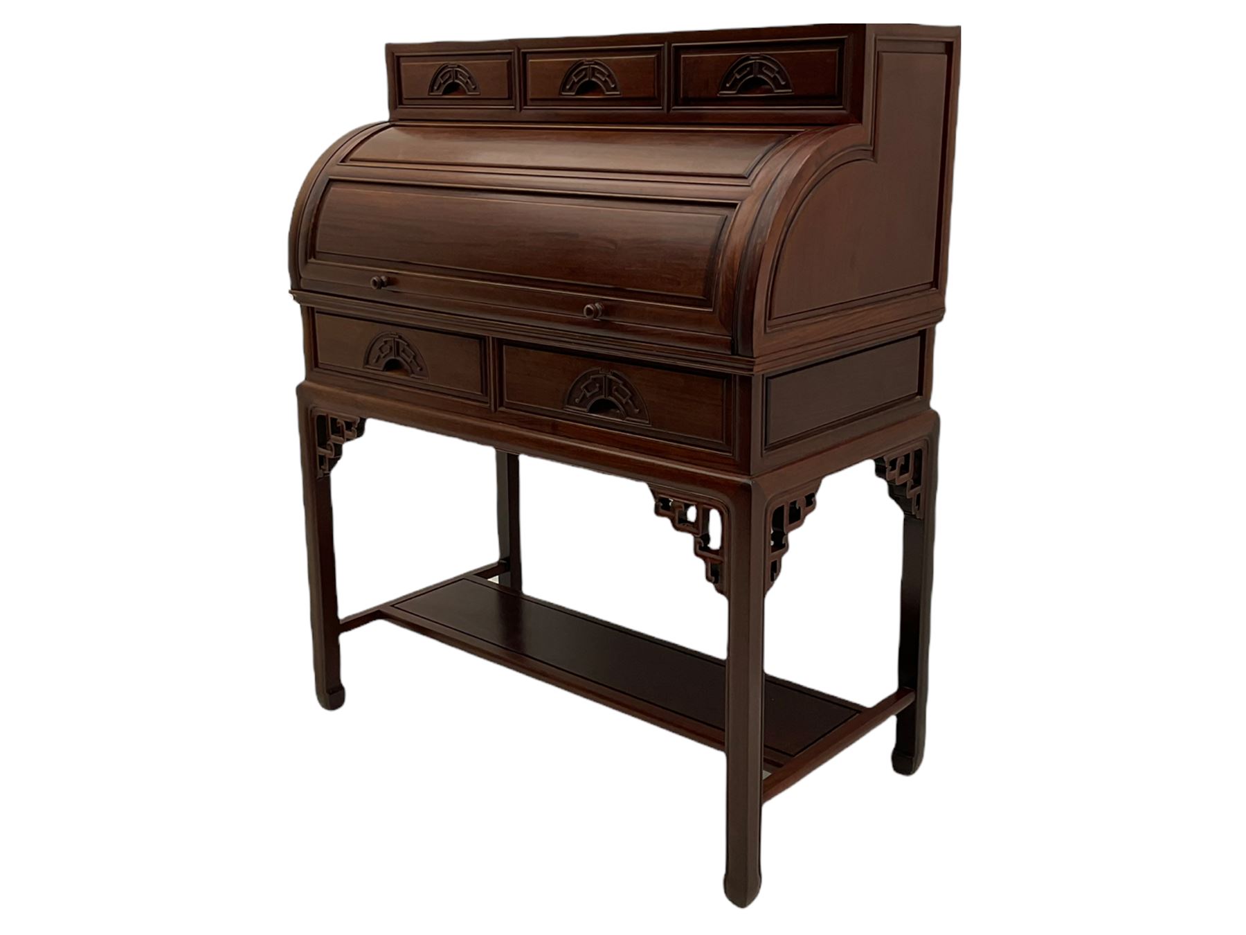 Hardwood cylinder desk, three drawers raised over curved lid, fitted interior with slide, the supports joined by undertier with fret work brackets 