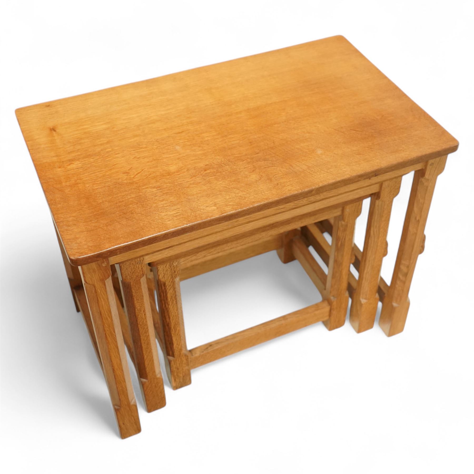 Mouseman - nest of three oak occasional tables, rectangular adzed top, on octagonal supports united by plain stretchers, each carved with mouse signature, by the workshop of Robert Thompson, Kilburn 