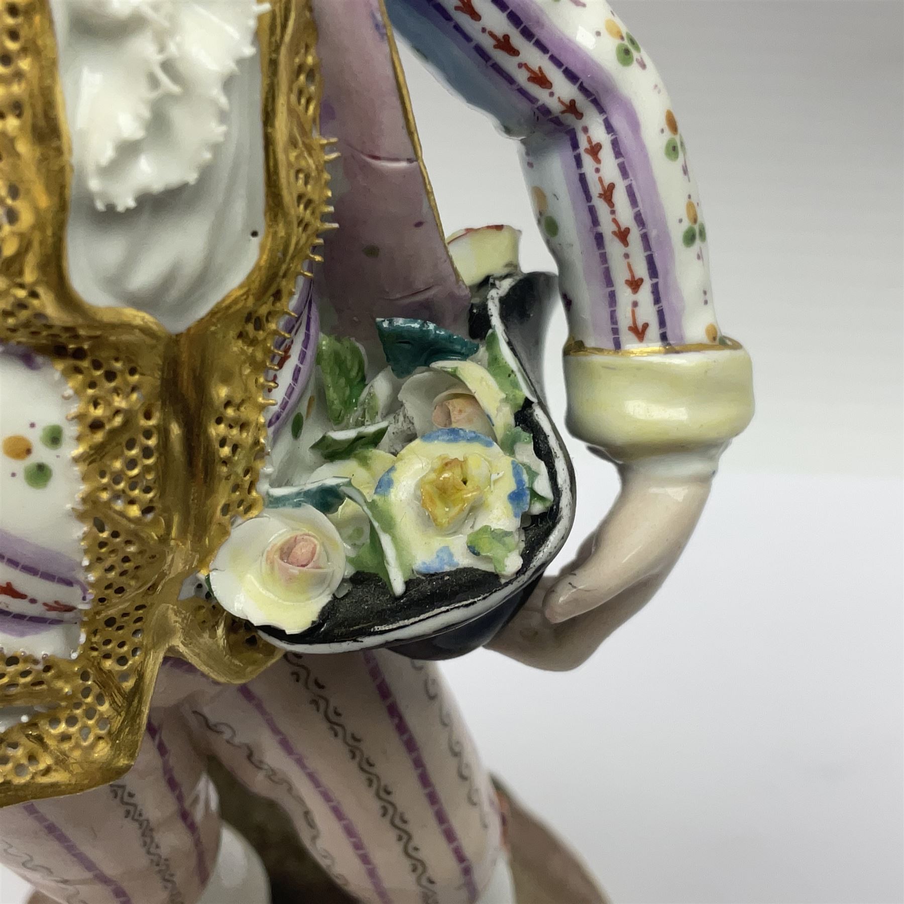 Pair of late 19th/early 20th Century Meissen figures, modelled as flower sellers, after the original by Michel Victor Acier, she holding basket of flowers, he holding flowers in his hat, each with underglaze cross swords mark beneath, tallest H16.5cm