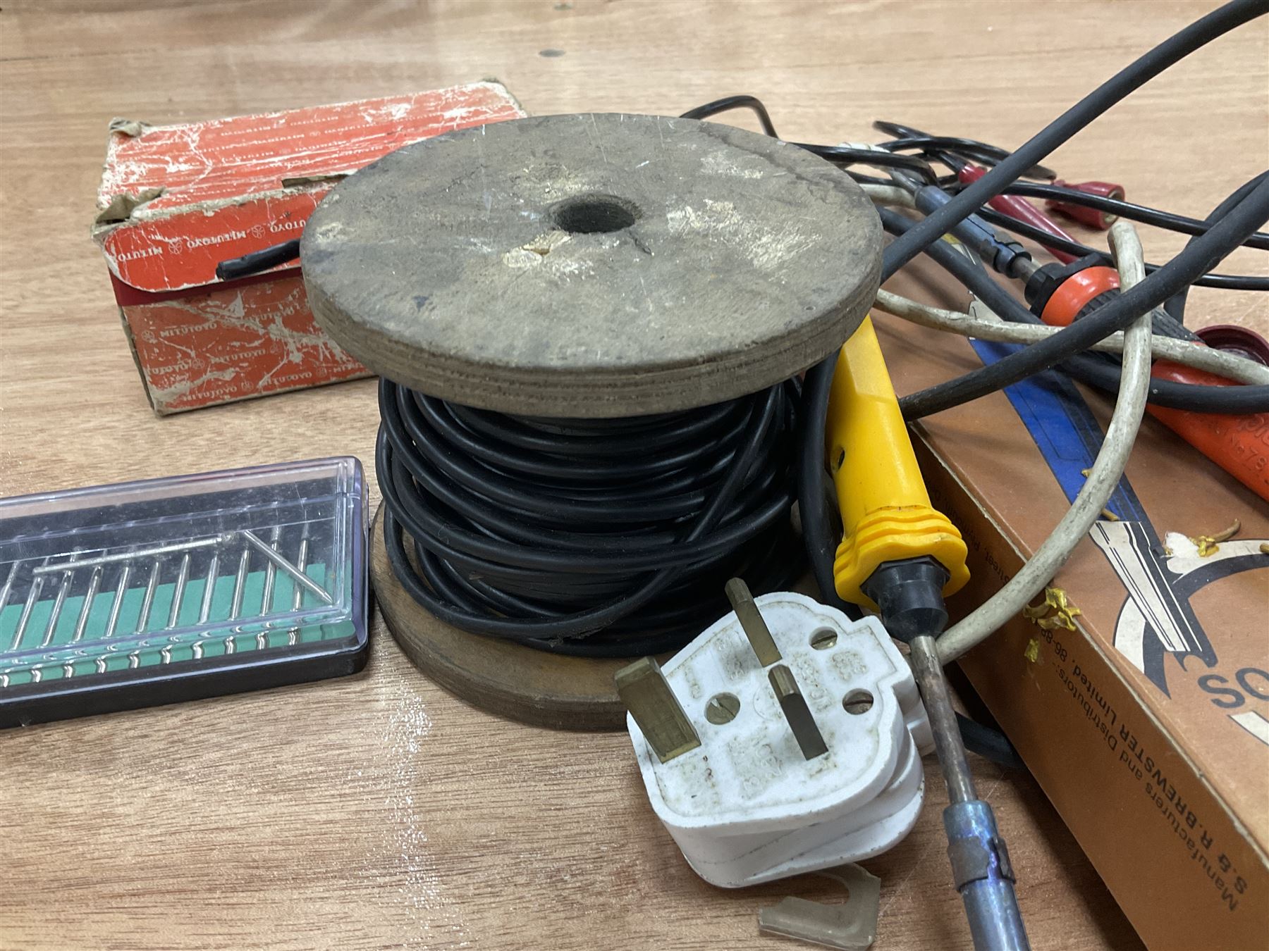 Six shelved cabinets for displaying ‘00’ gauge locomotives comprising plain plywood and white painted examples with track applied to various shelves, largest H63cm, W107cm, D27cm; Collection of tools for building model locomotives to include Weller PU-2D Soldering Pencil and Standard Tip Soldering Iron 20W/230V, Humbrol Modellers Airbrush, Power Supply Units and two wooden chests one of which housing a collection of tools including tweezers, scalping tools, wrenches etc 
