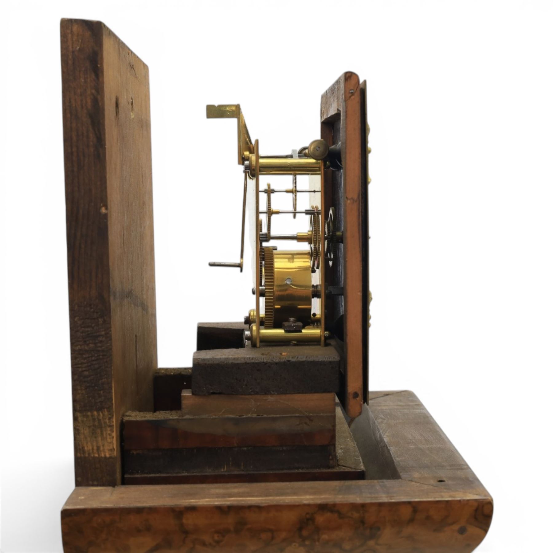 Early 20th century walnut small longcase clock, brass dial with silvered Roman numeral chapter ring and pierced black hands, the figured walnut case with shaped projecting hood, long moulded trunk door and stepped plinth base