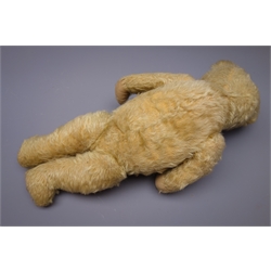  Early 20th century teddy bear, the plush covered body with squeaker mechanism, revolving head with applied eyes and stitched features to the pronounced snout, humped back and jointed limbs with upturned paws to the arms H52cm  