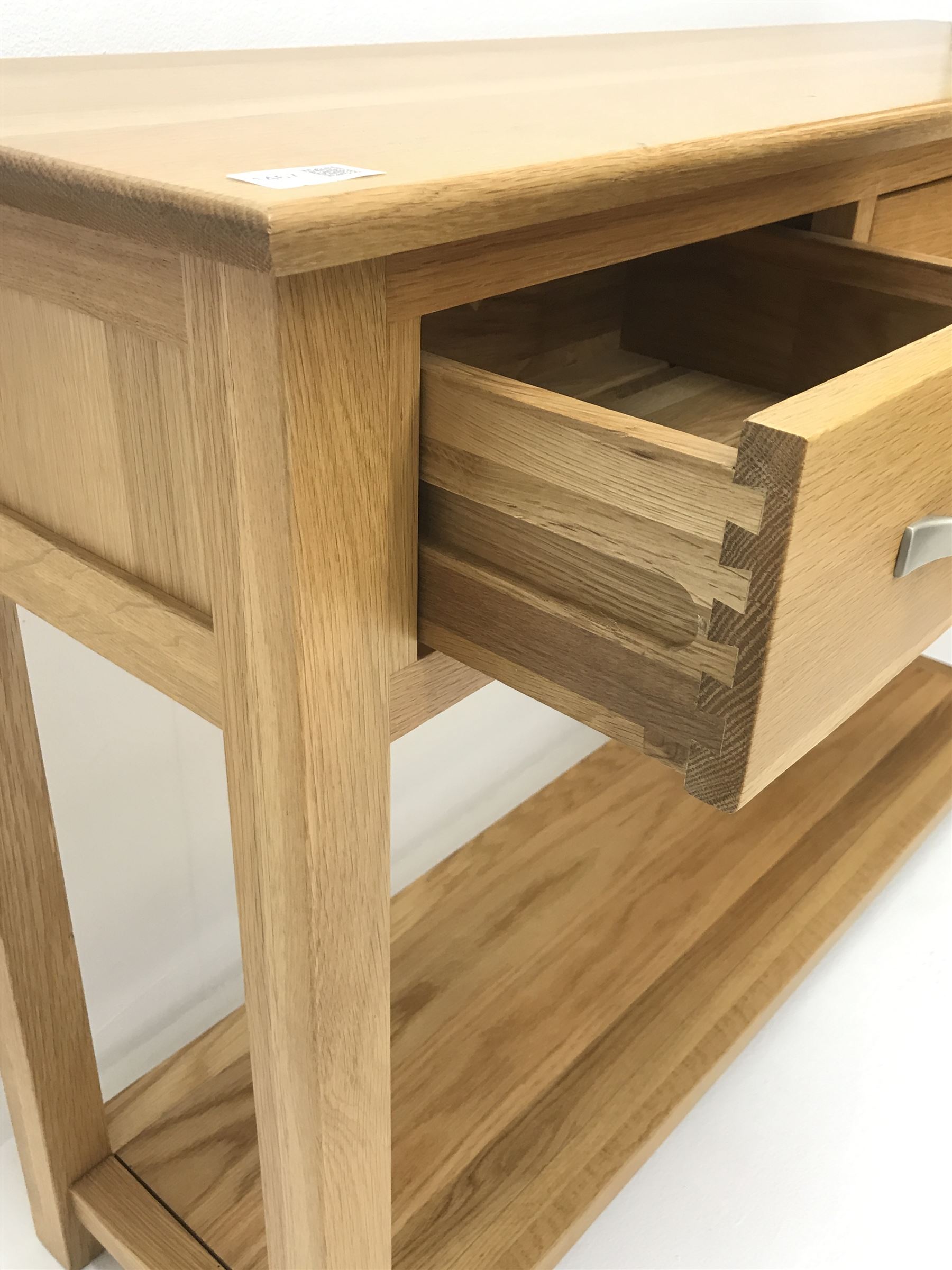 Light oak side console table, three drawers, square supports joined by