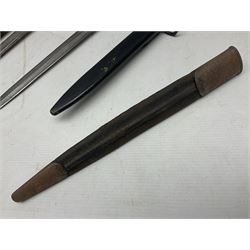 British No 7 MKI knife bayonet with 20cm single edged fullered clipped point blade;  blackened steel, large muzzle ring cross-guard; blackened swivelling pommel marked 'F5H'; red Tufnol composite grips; in blackened steel scabbard L33cm overall; British Pattern 1888 bayonet with scabbard; and German Ersatz bayonet with scabbard (3)